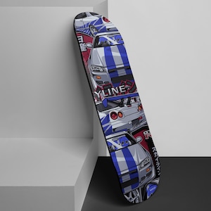 May include: A black skateboard deck with a colorful design featuring multiple white cars with blue and red accents. The cars are a Japanese Skyline GT-R model. The design includes Japanese text.
