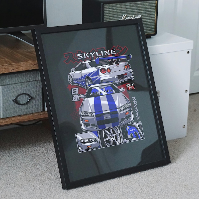 May include: A black framed print featuring a white and blue Nissan Skyline GT-R with the text "SKYLINE" in Japanese characters. The print also includes a close-up of the car's wheels and interior.