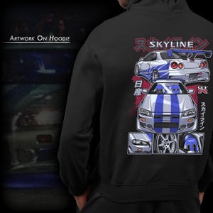 May include: Black hoodie with a white and blue graphic of two Nissan Skyline GT-R cars. The graphic includes Japanese text that says "Skyline" and "GT-R".