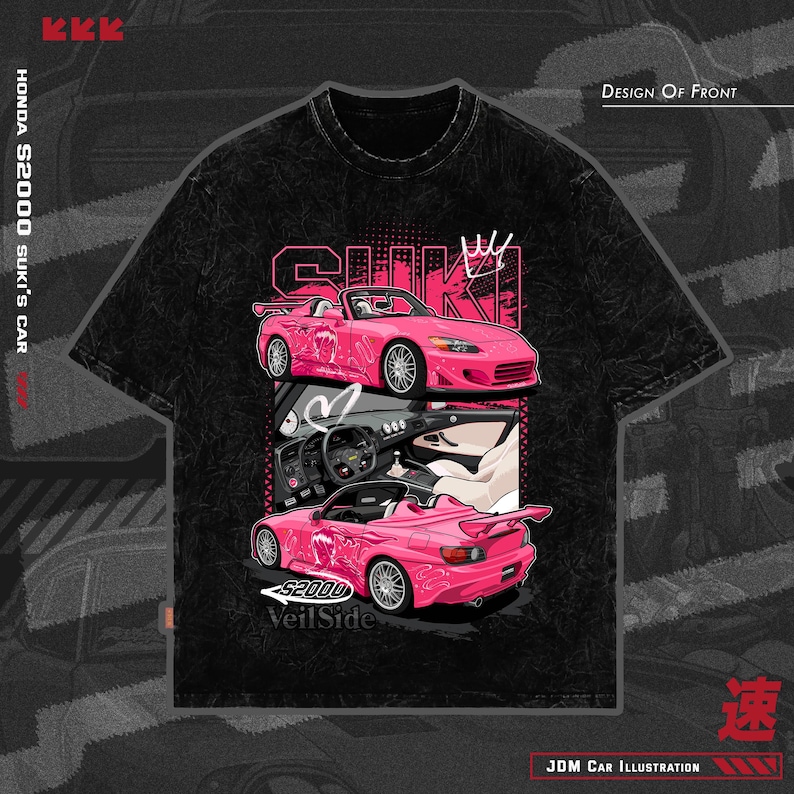 May include: Black t-shirt featuring a pink Honda S2000 car illustration. The design includes the text "SUKI" and "Veil Side", along with Japanese characters and the phrase "JDM Car Illustration". The shirt has a crew neck.