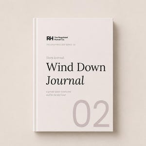 May include: A light beige hardcover journal titled Wind Down Journal with the text The Regulated Human Co. and The Daily Practice Series 02 printed on the front cover. The number 02 is displayed in a large, light grey font at the bottom right.