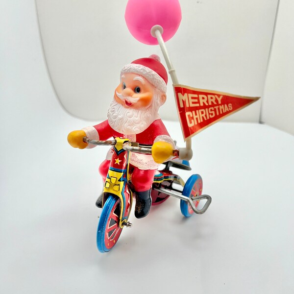 Antique toy Santa Claus riding a tircycle, metal wind-up toy, celluoid Santa with Merry Christmas banner, works great, bell rings, rare find