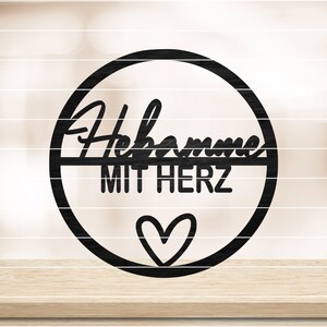 May include: Black metal circle sign with the text "Willkommen mit Herz" and a small heart in the center.
