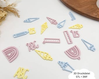 Könnte beinhalten: Verschiedene pastellfarbene 3D-gedruckte Formen, darunter Bleistifte, Eiswaffeln, Lineale, Buchstaben und Regenbogen. Die Formen sind in Hellblau, Rosa und Gelb gehalten. Die Formen sind auf einer weißen Oberfläche verstreut.