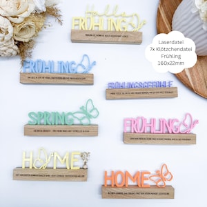 Könnte beinhalten: Sieben Holzschilder mit Frühlingsmotiven und Schmetterlingsdesigns. Die Schilder zeigen die Wörter "Hallo Frühling", "Frühling", "Frühlingsgefühle", "Spring", "Frühling", "Home" und "Home". Jedes Schild hat einen Schmetterling und einen Text in einer anderen Farbe.