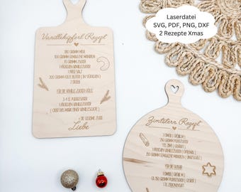 May include: Two wooden cutting boards with heart-shaped handles, engraved with recipes. One is rectangular, the other round. The text "Vanillekipferl Rezept" and "Zimtstern Rezept" are visible. The image also includes text that says "Laserdatei SVG, PDF, PNG, DXF 2 Rezepte Xmas".
