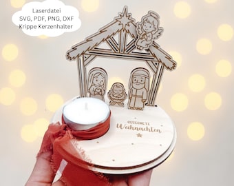 May include: A wooden Christmas nativity scene candle holder. The laser-cut design features Mary, Joseph, baby Jesus, and an angel. The base holds a tea light candle and is decorated with a red ribbon. Text on the holder reads "Gesegnete Weihnachten".