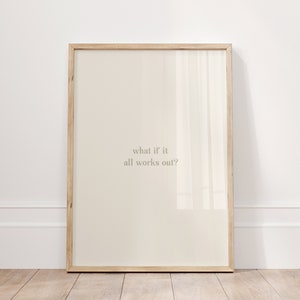 May include: A framed print with a light beige background and the text "what if it all works out?" in a light gray font.