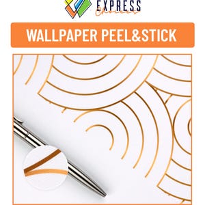 May include: A close-up of a gold peel and stick wallpaper with a geometric pattern of overlapping circles. A silver pen is lying on top of the wallpaper, showing the texture of the material.