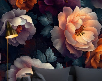 May include: A dark gray couch with two pillows in front of a wall with a floral pattern. The flowers are in shades of purple, orange, and white.