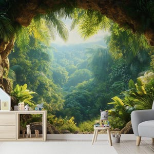 May include: A vibrant jungle-themed mural featuring lush green foliage, a cave-like opening, and a bright sky. A light wood cabinet with toy houses and animals sits in front of the mural, with a gray armchair to the right.