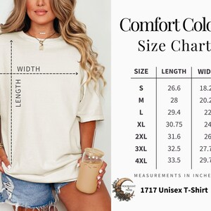 May include: Cream-colored unisex t-shirt with a size chart. The chart lists sizes S to 4XL, with length and width measurements in inches. The text on the shirt reads "Comfort Colors" and "1717 Unisex T-Shirt".