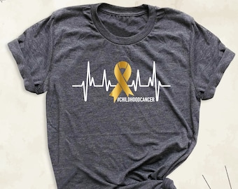 Camiseta de concientización sobre el cáncer infantil, camiseta de Tiny Warrior, camiseta de apoyo familiar contra el cáncer infantil, camisetas de cáncer infantil con lazo dorado, camiseta "We Wear Gold"