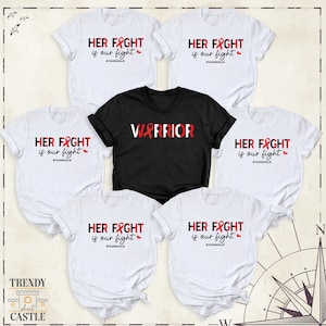 May include: Five white t-shirts with red ribbon designs and the text "HER FIGHT is our fight #TEAMNATALIE" and one black t-shirt with the text "WARRIOR" in red with a red ribbon design.