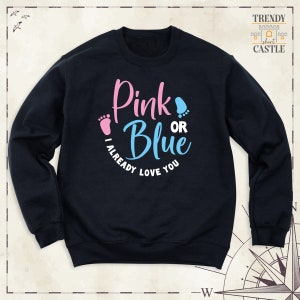 May include: A black sweatshirt with the text "Pink or Blue I Already Love You" in pink and blue lettering. The text is surrounded by two pink and blue footprints.