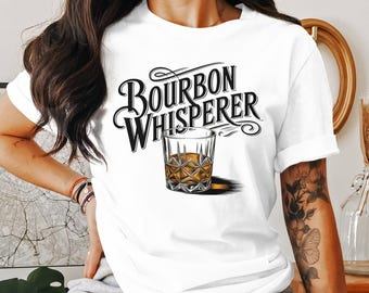 May include: White t-shirt with the text "Bourbon Whisperer" in black lettering and a glass of bourbon whiskey.