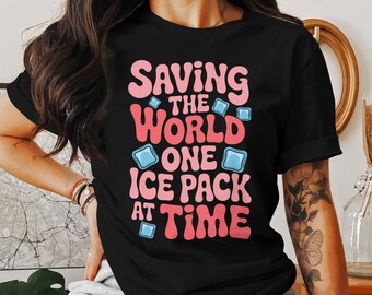 May include: Black t-shirt with the phrase "Saving the World One Ice Pack at a Time" in pink and red bubble letters. The design includes ice cube graphics. The shirt is a casual wear item.