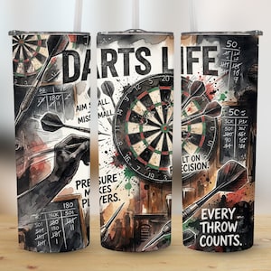 May include: A cylindrical tumbler with a watercolour design featuring a dartboard, darts, and the words "DARTS LIFE." The design includes the text "EVERY THROW COUNTS" and a chalkboard with scoring information.