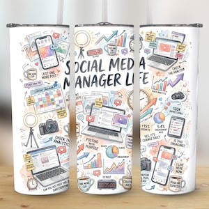 May include: A white tumbler with a wrap-around design featuring social media-related illustrations. The text "SOCIAL MEDIA MANAGER LIFE" is prominently displayed. The design includes phones, laptops, cameras, and social media icons.