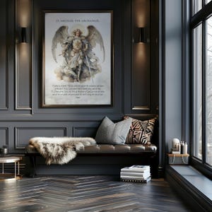May include: A framed print of St. Michael the Archangel hangs on a dark gray wall. The artwork depicts the angel with wings, holding a sword. Below the image is a passage of text. A bench with pillows and a faux fur throw sits below the artwork.