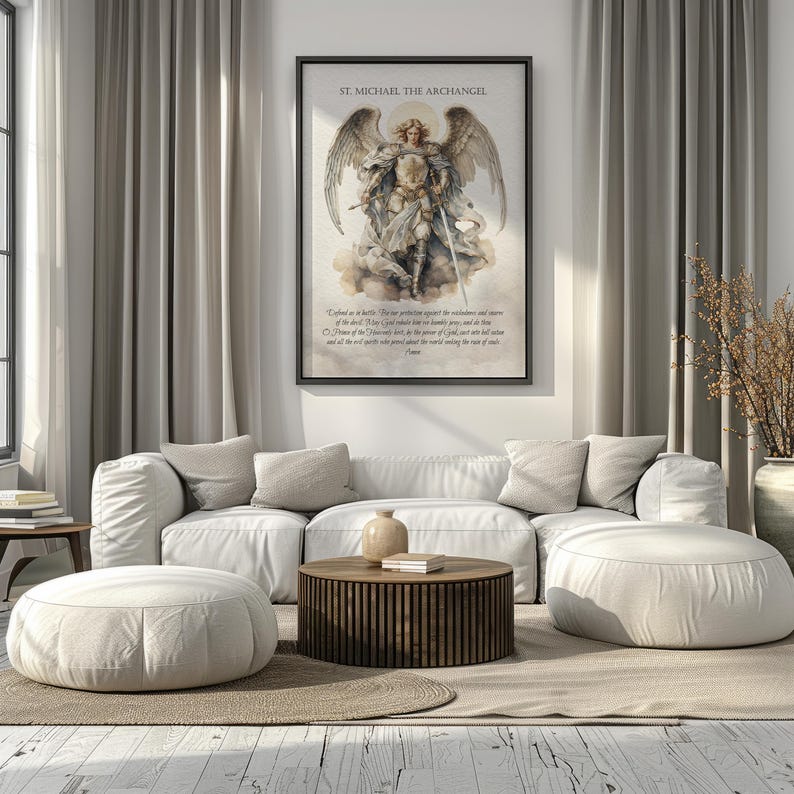 May include: A framed print of St. Michael the Archangel hangs above a white sectional sofa. The artwork depicts the archangel with wings, holding a sword. The room features neutral tones, a wooden coffee table, and two round ottomans.