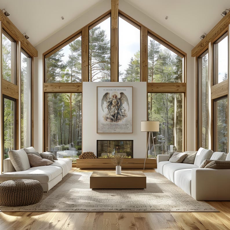 May include: A bright, airy living room with large windows offering a view of a forest. The room features white sofas, a wooden coffee table, a fireplace, and a framed artwork. The decor is modern and minimalist, with natural wood accents.