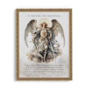 May include: A framed print featuring St. Michael the Archangel, depicted with large wings, armor, and a sword. The artwork has a golden frame and includes text at the top and bottom. The text reads "ST. MICHAEL THE ARCHANGEL" and a prayer.