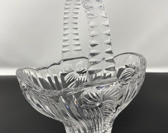 Vintage crystal cut glass small basket. Intricate details and flowers on both sides with a ribbed handle. No chips or cracks.