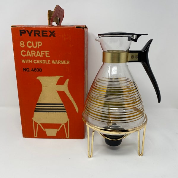 PYREX 1960s 8 cup carafe with candle warmer. Preowned w/o cracks or chips. Comes with original box. Removable candle warmer. Stands 8.5”