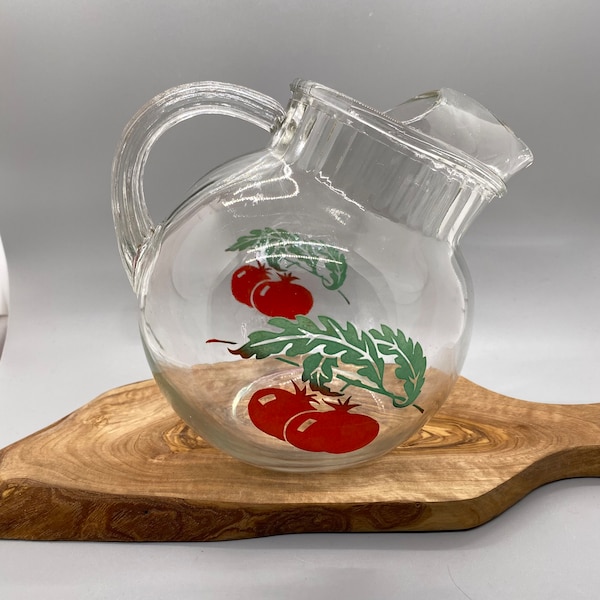 Hand Blown Vintage Glass Tilted Ball Pitcher with Ice Lip. Tomato design on both sides. Holds approx 38 ounces. Preowned w/o chips or cracks