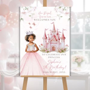 May include: A pink and white princess-themed birthday party sign on an easel. The sign features a watercolor illustration of a castle, a young girl in a princess dress, and the text "Her Royal Highness Welcomes You". The sign is for Sophia's 5th birthday.