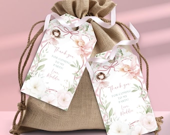 May include: A burlap gift bag with two attached gift tags. The tags feature a fairy illustration, floral accents, and the text "Thank you for coming to my party! Love, Maddie."