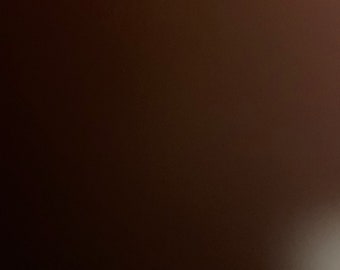 May include: A solid brown background with a slight gradient from dark to light.