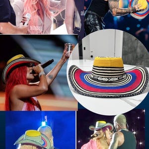 May include: A wide-brimmed hat featuring a yellow crown, a black and white striped band, and a multi-colored brim with concentric rings of red, blue, and black. The hat has a woven texture and a distinct geometric pattern around the base of the crown.