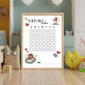 May include: A framed Bible reading tracker with the text "My Bible Reading Tracker". The tracker has a grid for marking daily progress, with illustrations of Jesus and hearts. The frame is light brown.