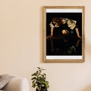 May include: A framed painting of a young man in a dark setting, looking down at his reflection in a pool of water. The man is wearing a white shirt and blue pants. The painting is in a wooden frame.