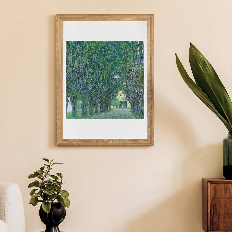 May include: A framed painting of a tree-lined path leading to a building. The trees are green and the path is lined with white stones. The building is a light yellow color with a white roof.