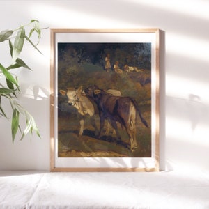 May include: A framed painting depicting two calves in a field. The calf on the left is white with brown markings, while the calf on the right is brown. The painting is set against a backdrop of green trees and a blue sky.