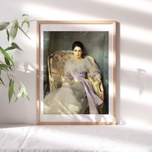 May include: A framed painting of a woman in a white dress sitting in a floral patterned armchair. The woman is wearing a purple sash and has a serious expression on her face.