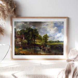 May include: A painting of a rural landscape with a cottage, a river, and a wagon being pulled by oxen. The sky is cloudy and the trees are green. The painting is in a wooden frame.