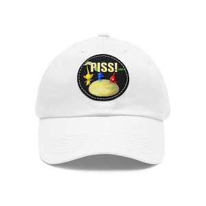 May include: White baseball cap with a black and white circular patch featuring three cartoon characters and the word "PISS!" in yellow letters.