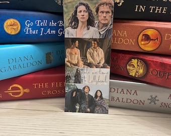 May include: A multi-panel bookmark featuring scenes from the Outlander TV series. The bookmark includes images of Claire and Jamie Fraser, as well as the text "Take me home to Lallybroch".