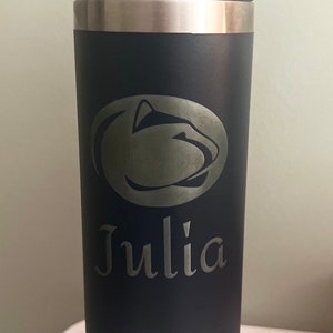May include: A black Yeti Rambler with a silver lid and handle. The bottle has a silver Penn State Nittany Lion logo and the name "Julia" engraved on the side.