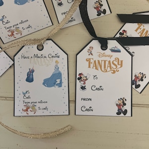 May include: A set of Disney Cruise gift tags featuring a blue and white cruise ship, Mickey Mouse, and Cinderella. The tags are printed with the words "Disney Fantasy" and "Have a Magical Cruise".