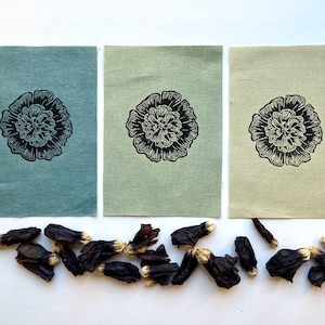 May include: Three fabric swatches with a black and white floral print. The swatches are in shades of teal, green, and beige.