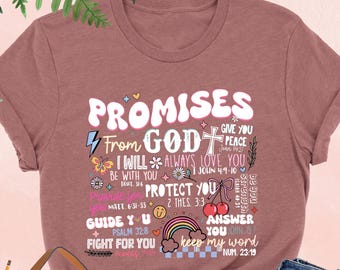 May include: A heather mauve t-shirt with a graphic design of colorful text that reads "Promises from God" and includes bible verses. The text includes phrases like "I will always love you", "Protect you", "Guide you", "Fight for you", and "Keep my word".