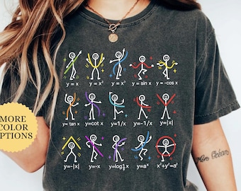May include: A charcoal gray t-shirt featuring a graphic of fifteen white stick figures performing various poses that correspond to mathematical function equations printed in white text below each figure, including y=x, y=x², and x²+y²=a².