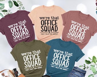 May include: Five t-shirts in different colours with the text "We're that Office Squad They told you about" printed on them.