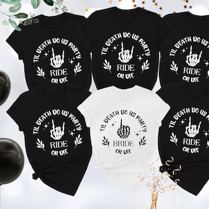 May include: Five black t-shirts with white text that reads "Til Death Do Us Party" with a skeleton hand making a rock and roll sign. One white t-shirt with the same text but the skeleton hand is making a peace sign and the text reads "Bride or Die".