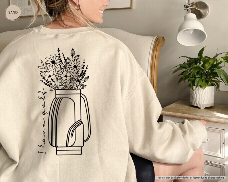 a woman sitting in a chair with a flower pot on her back